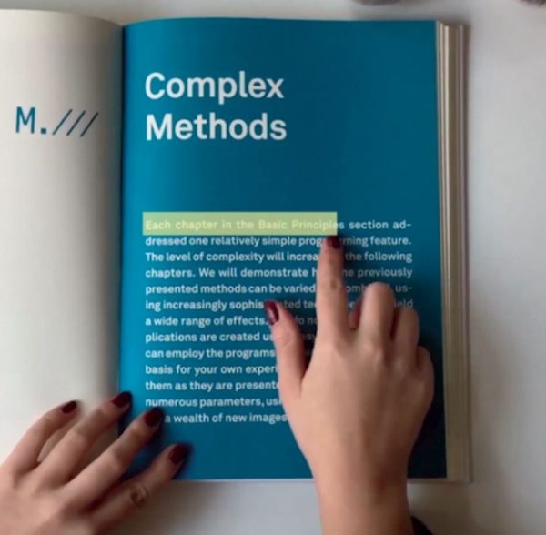 A finger highlighting a line of text on the page of a printed book