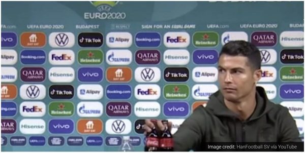 Cristiano Ronaldo moving Coca-Cola bottles aside at a press conference