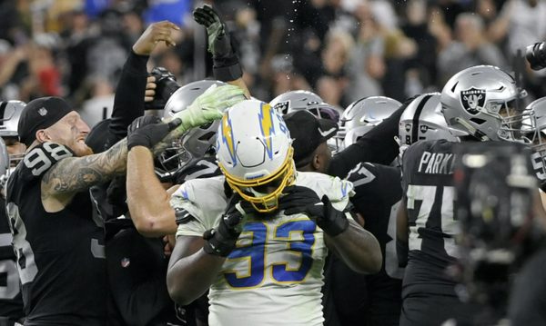 Raiders and Chargers players during their season finale