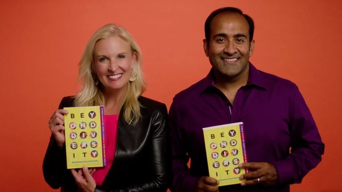 Rohit and Jennifer Brown holding Beyond Diversity