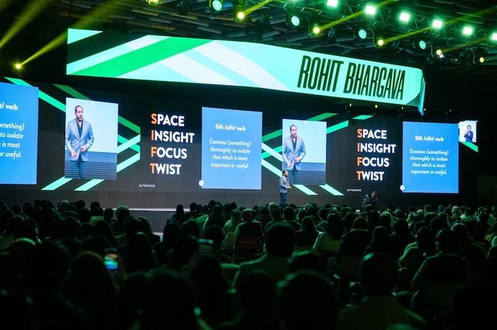 Rohit speaking on a large stage